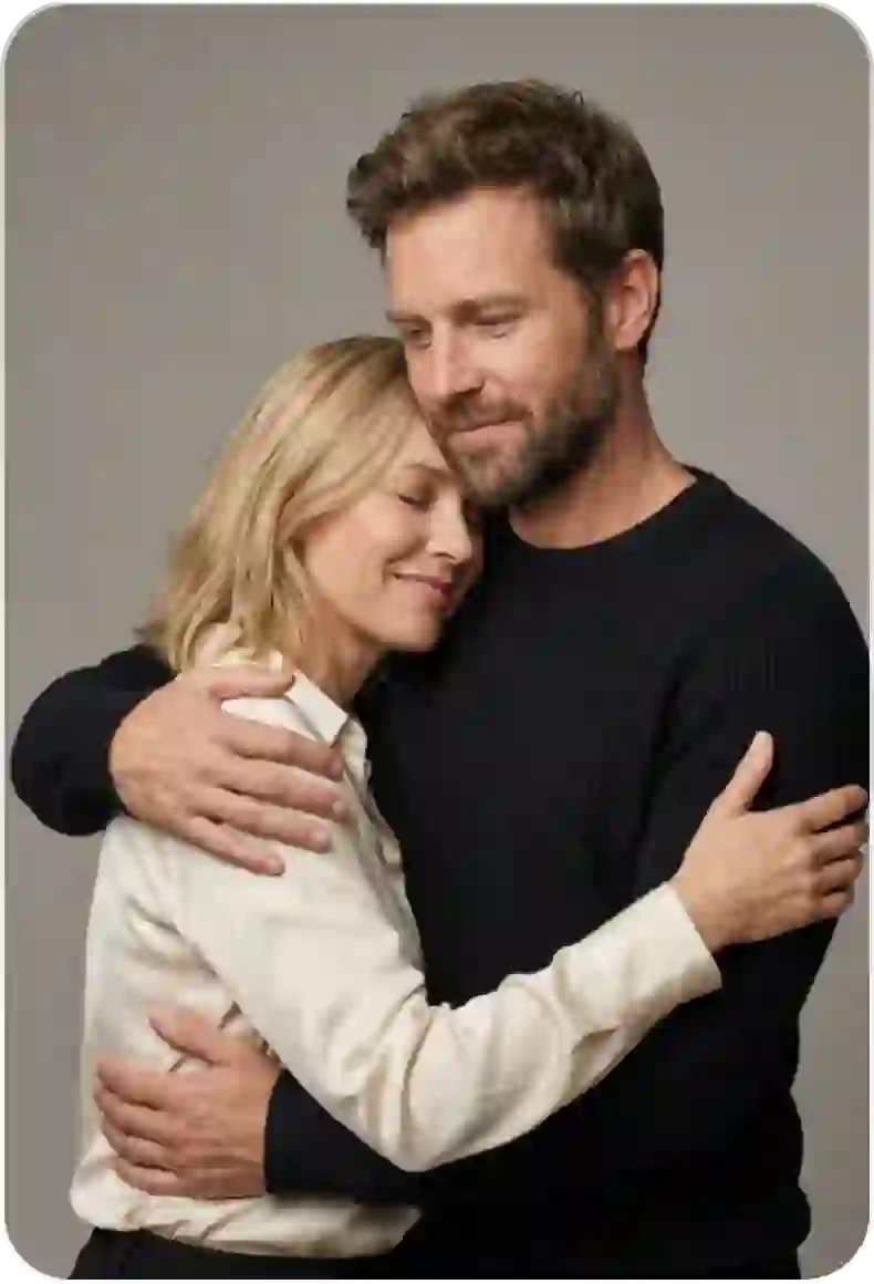 A couple uses the AI hug video tool, as they embrace each other on a rocky beach.