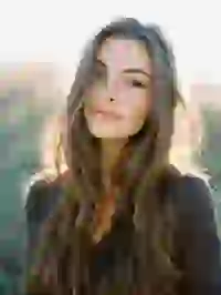 woman-in-sunlight Portraif of a smiling blonde woman in black long sleeve top standing in the sunlight. Template for Undress AI.