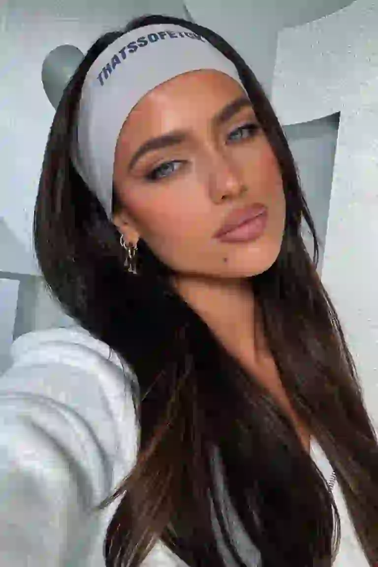 Woman in grey casual sports outsit posing confidently.