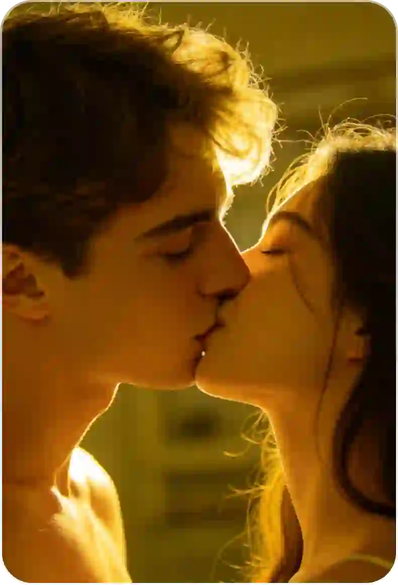 Photo of a couple kissing in a swimming pool, the man's shirtless, wearing floral swim shorts, the woman's wearing a floral swimsuit.