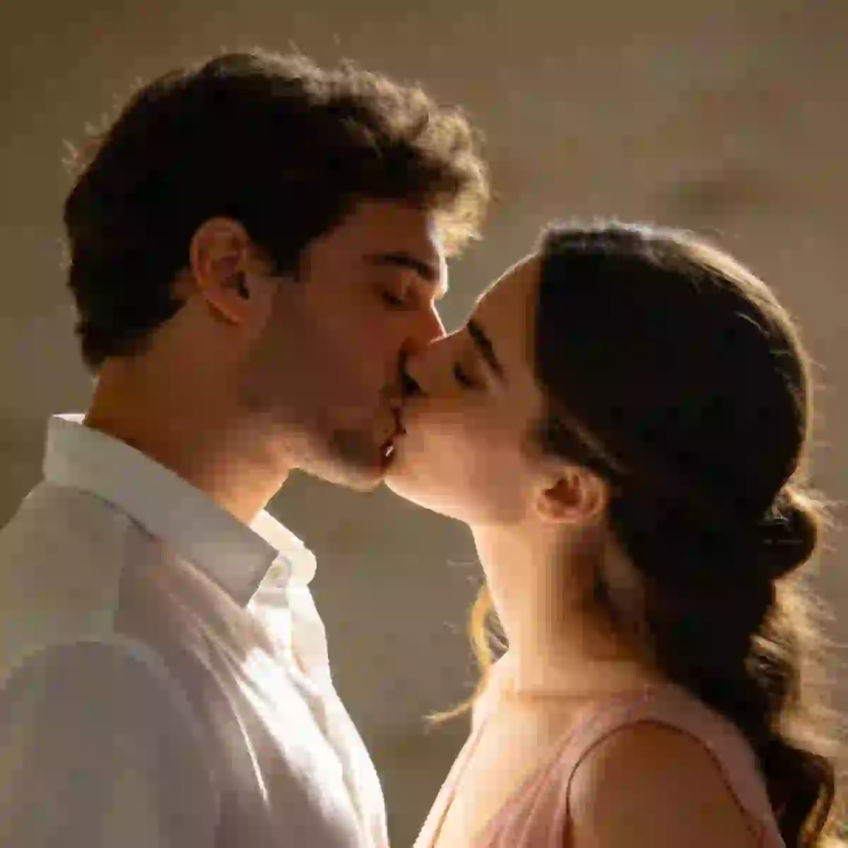 AI-generated image of a beautiful woman with long wavy hair and a handsome man with black curly hair and beard kissing in warm lighting.