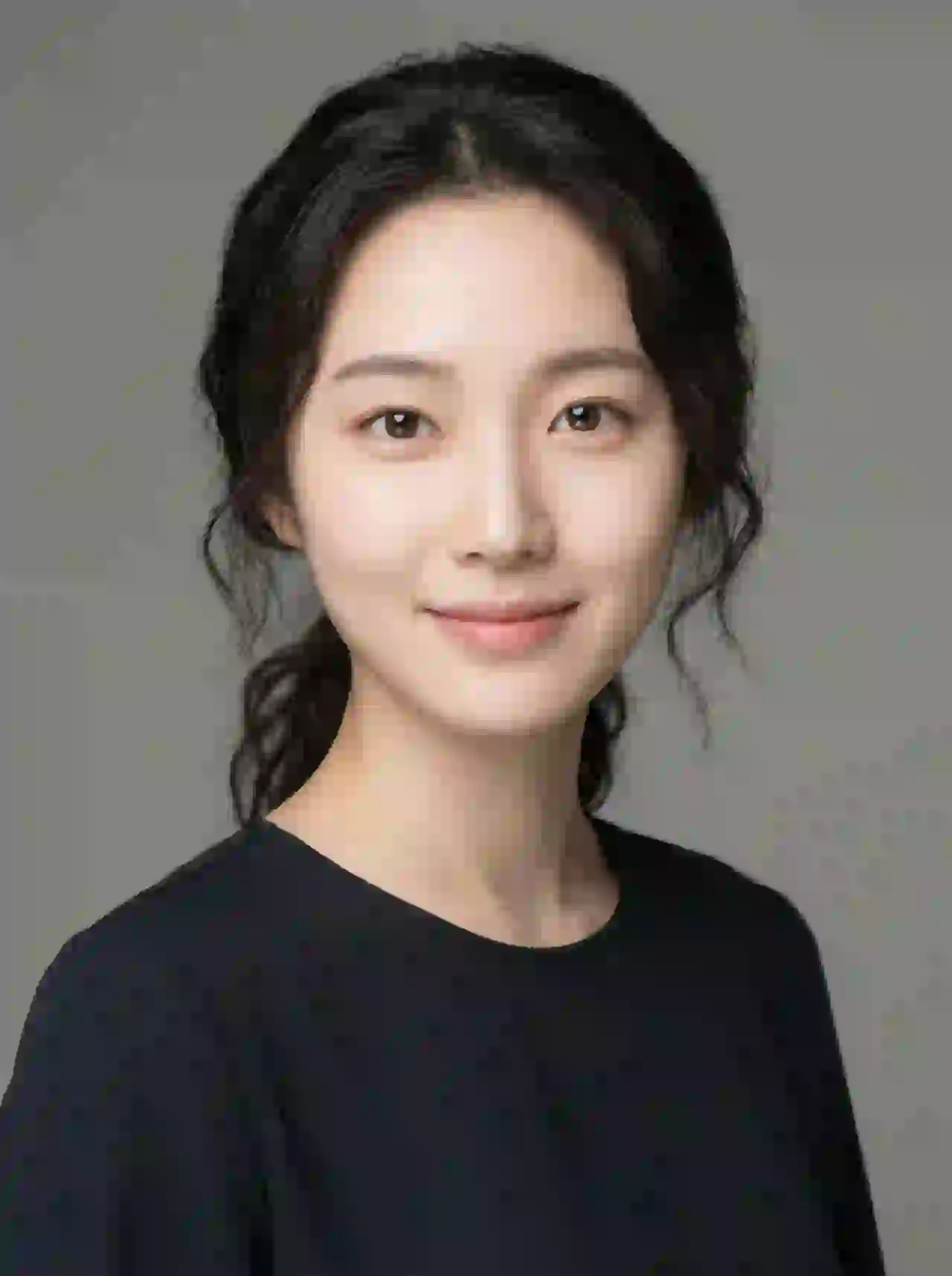 East Asian woman with wavy black hair and soft smile. Template for photo face swap.