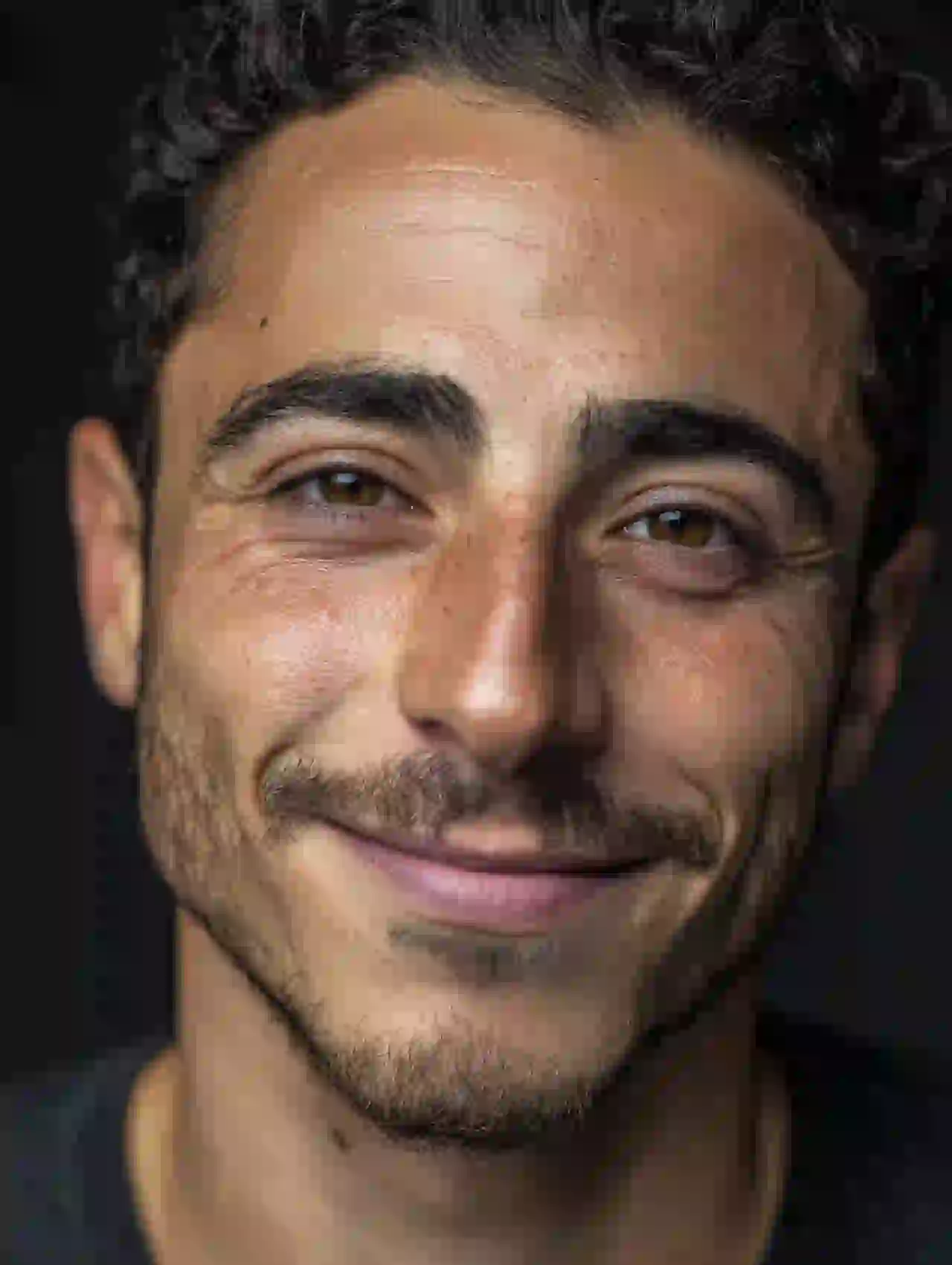 Middle Eastern man with stubble and warm smile in close-up. Template for photo face swap.