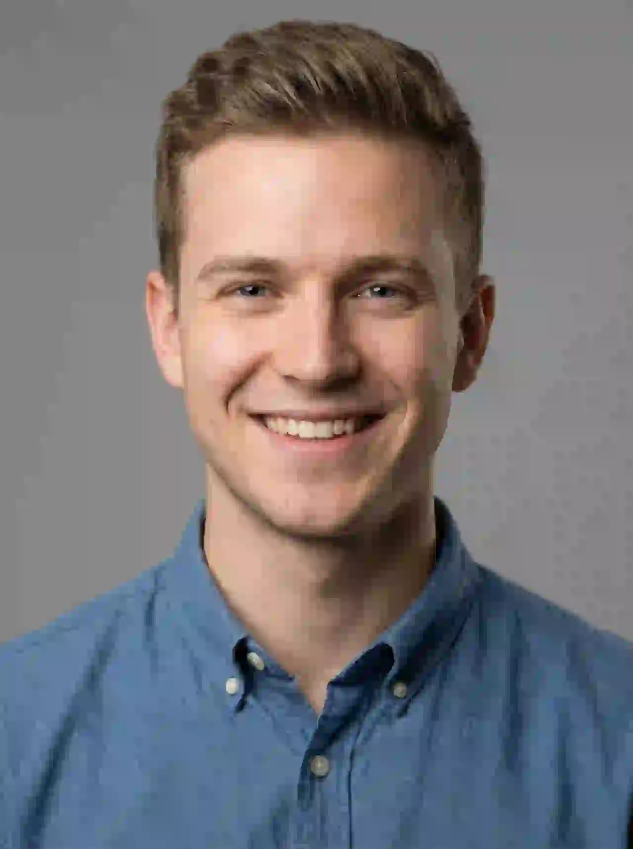 Young blonde man with blue eyes in denim shirt smiling. Template for photo face swap.